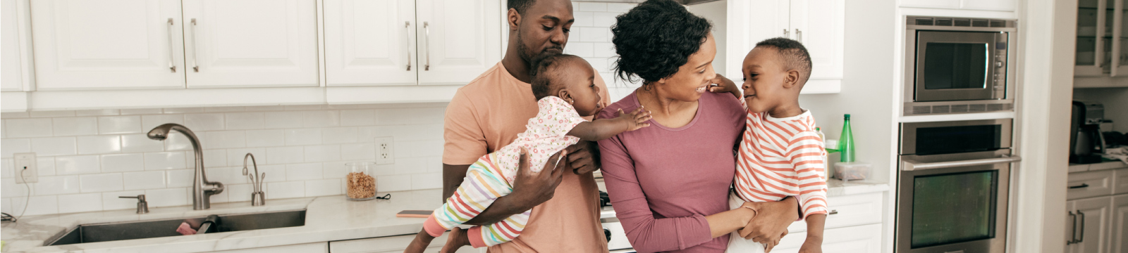 A family of four in a kitchen