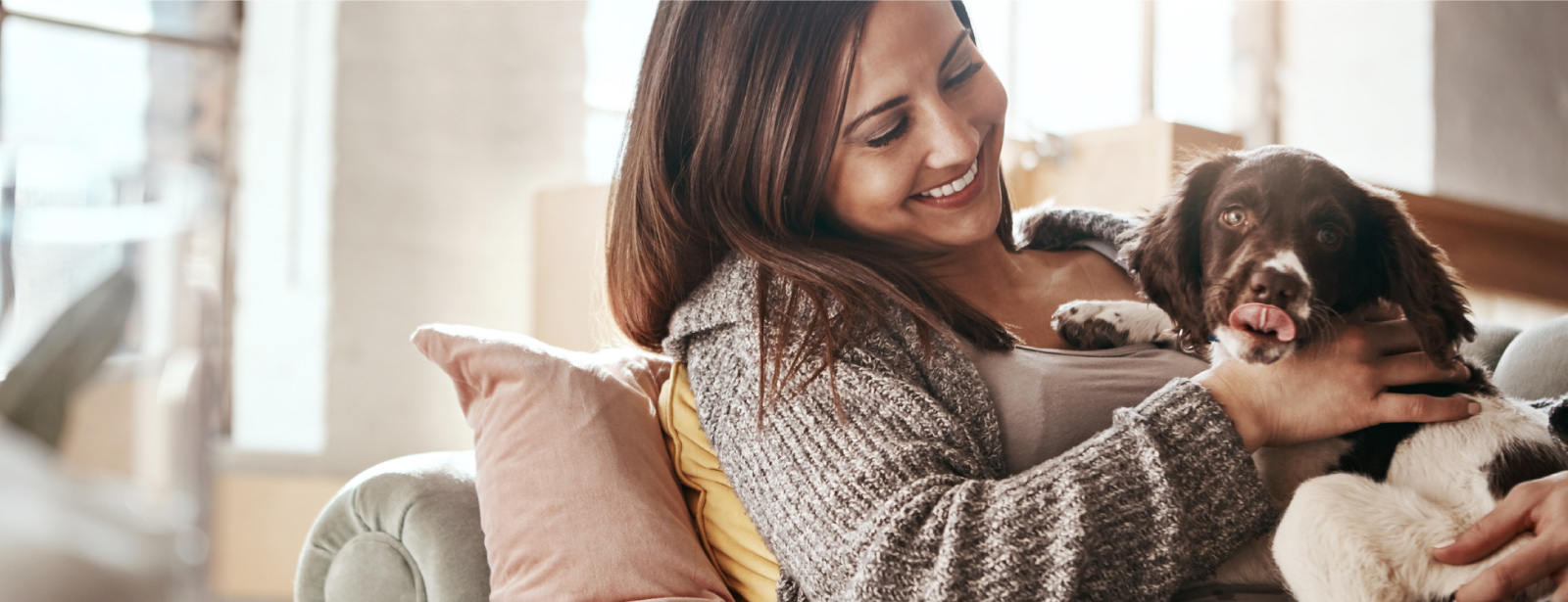 Young woman in home with puppy