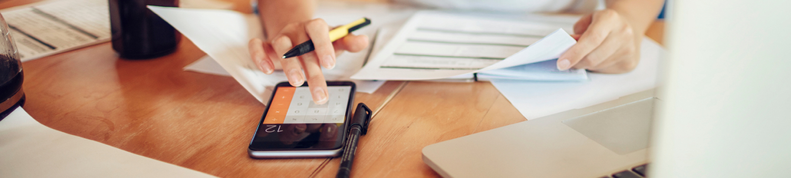 A woman using phone as calculator