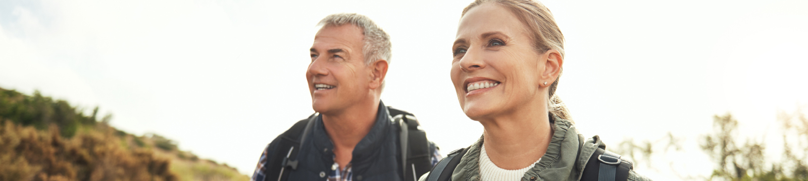 A mature couple smiling outdoors